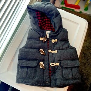 Baby Gap puffer vest with toggle closure and buffalo print plain on interior.